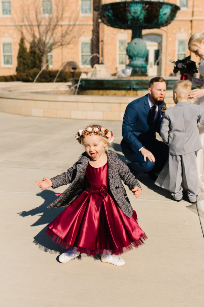 Little girl twirling in burgundy dress